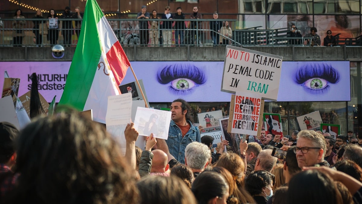a group of people holding signs and flags